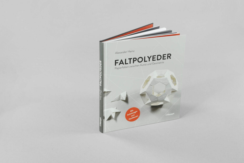 Buchcover von „Faltpolyeder“ mit farbigem Origami-Design auf weißem Hintergrund.